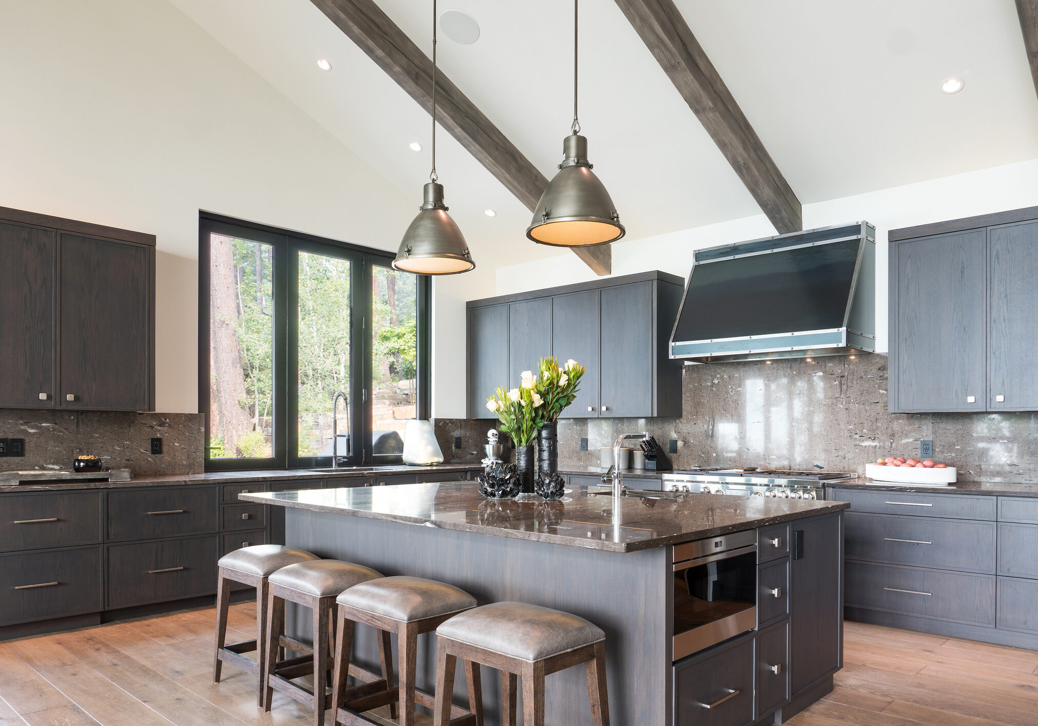 Kitchen island with four stools and two pendant lights above